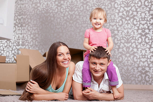 istock Cute friendly family is relaxing on floor 487112358
