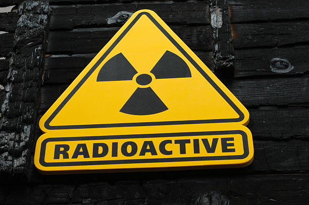 istock Radioactive Sign on Burned Wooden Background 487113264