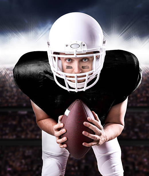 istock Football Player on black uniform in the stadium 487117622