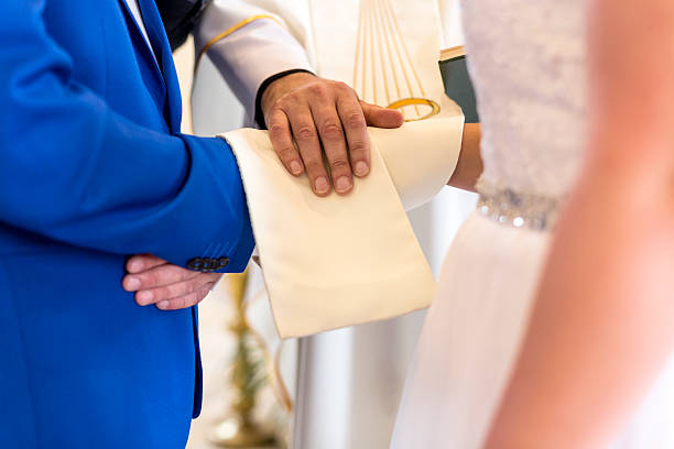 istock Wedding Ceremony With Hands Of Newlyweds And Priest 487117928