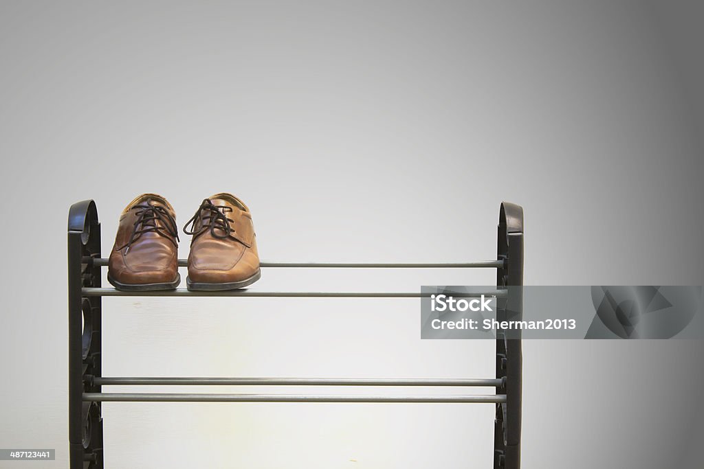 Shoes on Shoe Rack Lone shoe pair on a shoe Rack Stock Photo