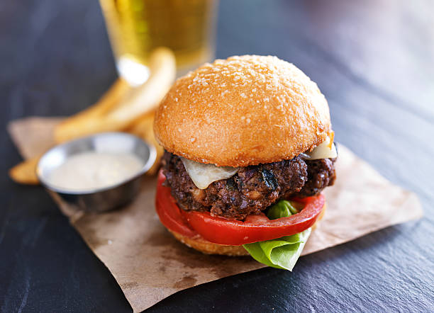 istock gourmet cheeseburger with fries, sauce and beer 487123514