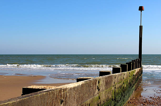 istock Image looking down groyne on sandy beach in Dorset, England 487123645