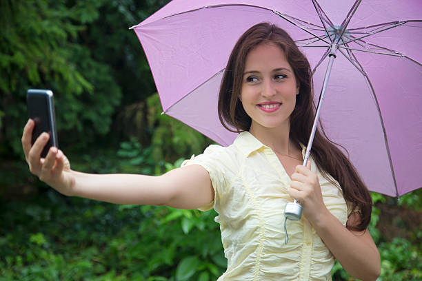 istock Smiling woman taking selfie with smartphone in nature. 487124228