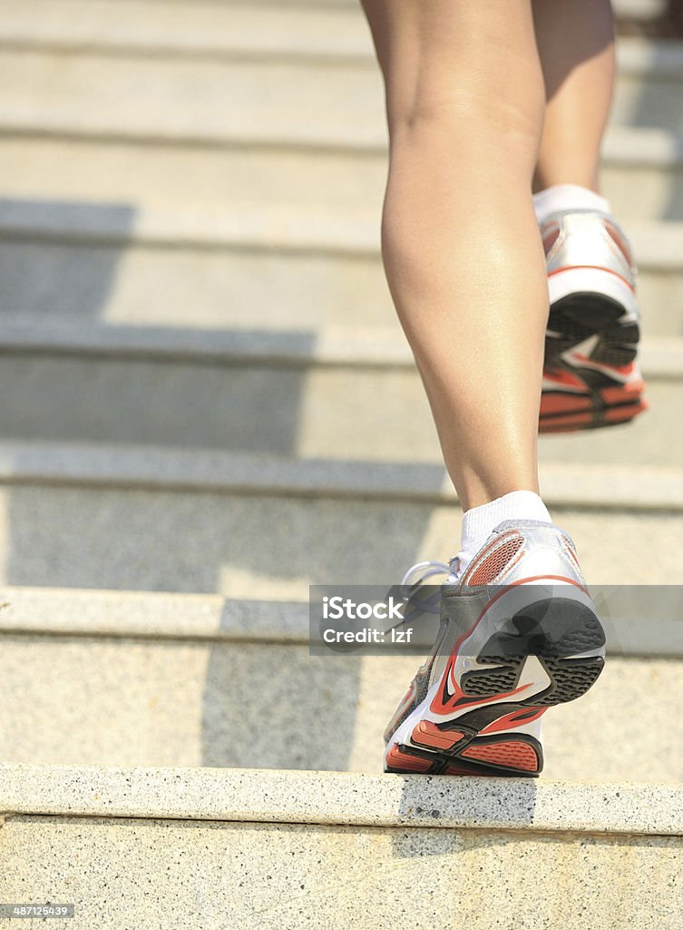 woman legs running up on mountain stairs healthy woman legs running up on mountain stairs to peak Jogging Stock Photo