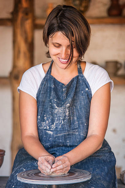istock Woman work on potter's wheel 487125829