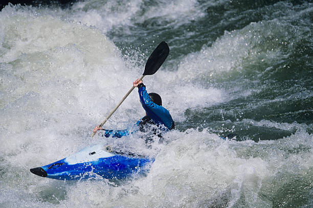 istock Kayaker Paddling Through White Water Rapids 487126439