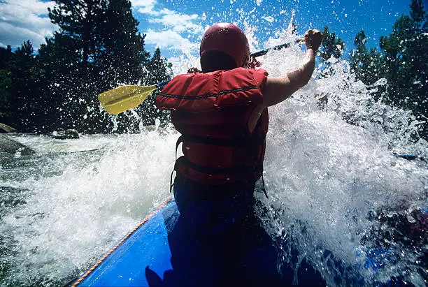 Photo of Kayaker Paddling Through Rapids