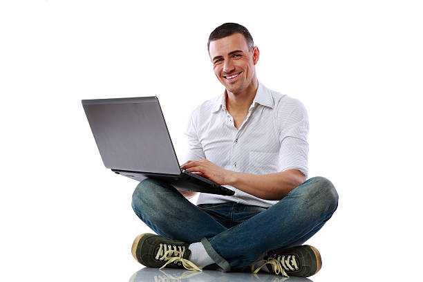 istock Happy man sitting at the floor with laptop 487126561