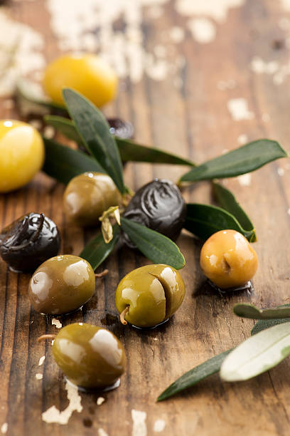 istock olives on wood bowl 487130660