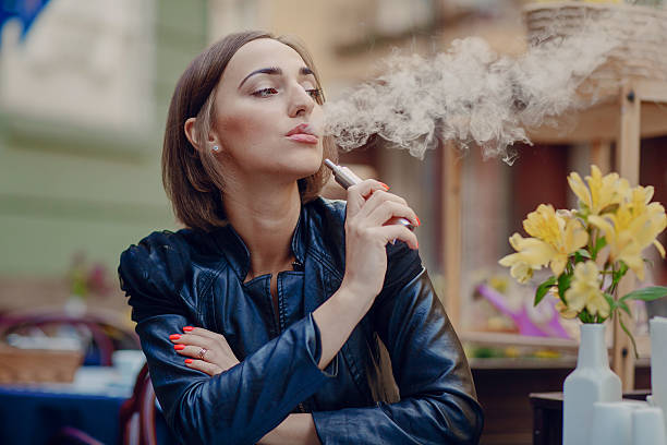 istock beautiful glamorous brunette smoke electronic cigarette 487131592