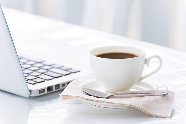istock Coffee cup and laptop for business 487132022