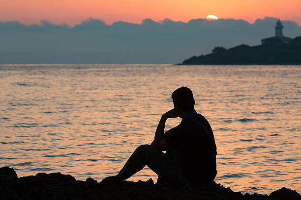 istock silhouette of thinking man in the sunrise 487132228