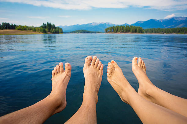 istock Couple relaxing on a beautiful Mountain Lake shore 487133158