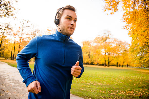 istock Man jogging and listening music 487136736
