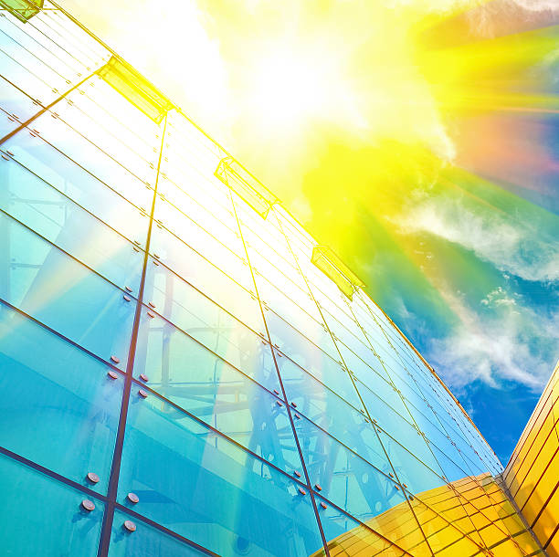 istock Sunlight of blue glass windows at closeup looking up 487136828