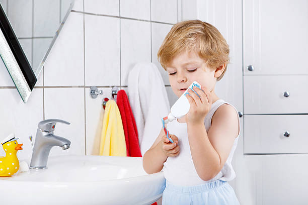 istock Lovely toddler boy brushing his teeth, indoors 487137040