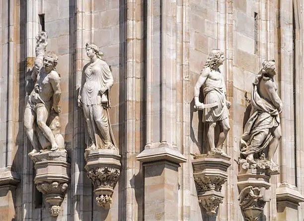 Four of the scores of statues that cover the four sides of the Milan Duomo.