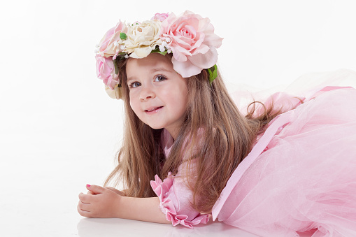 Little Princess and flower crown in white back ground with beautiful long pink dress.