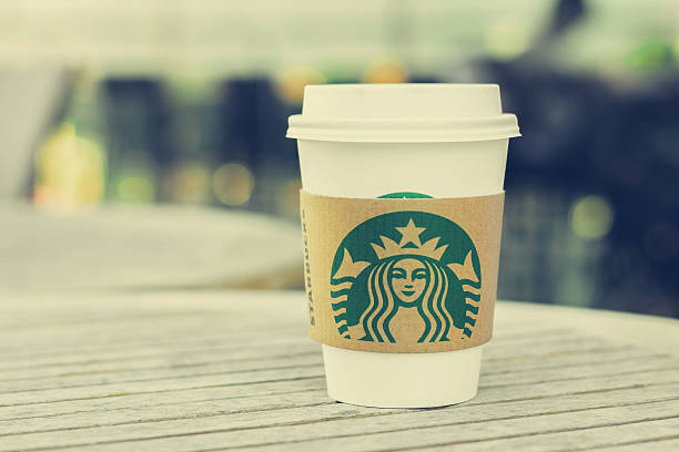 Bangkok, Thailand - Feb 26, 2015 : Starbucks coffee cup on the table, Starbucks brand is one of the most world famous coffeehouse chains from USA.