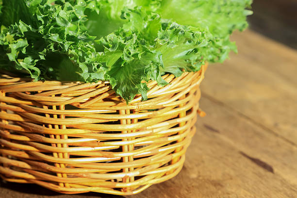 istock Green vegetables decorated on wooden background. 487138952