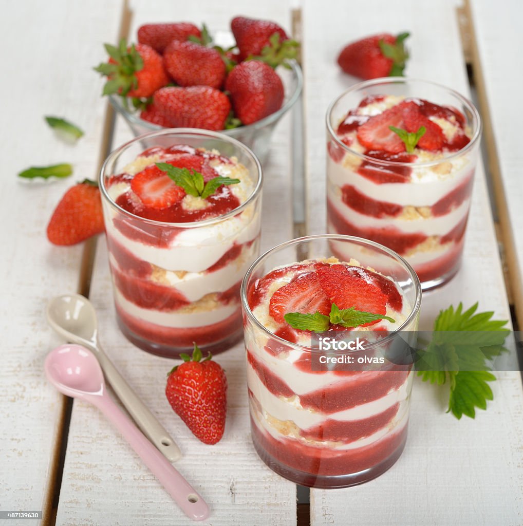 Dessert with strawberries and whipped cream Dessert with strawberries and whipped cream on a white background Strawberry Stock Photo