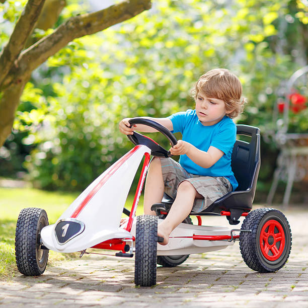 istock Active little boy having fun and driving toy race car 487145326