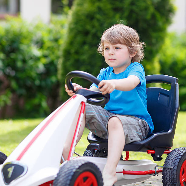 istock Active little boy having fun and driving toy race car 487145328