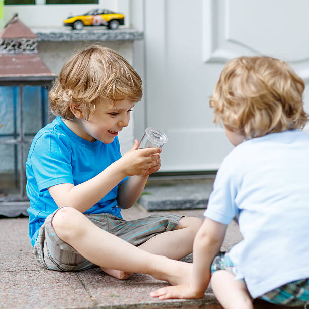 istock Two happy sibling boys having fun together outdoors 487145346