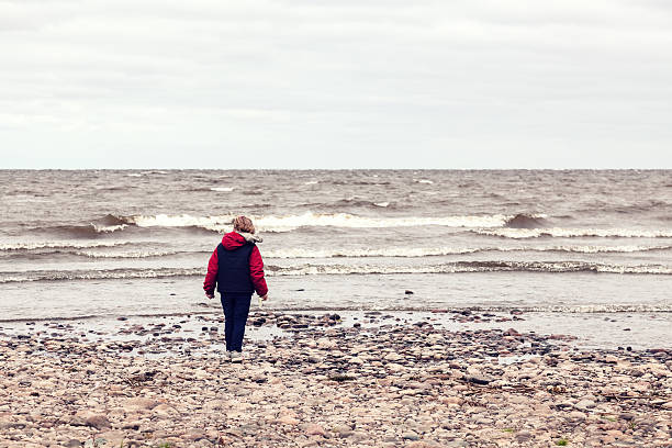 istock Girl walks along the lake 487149202