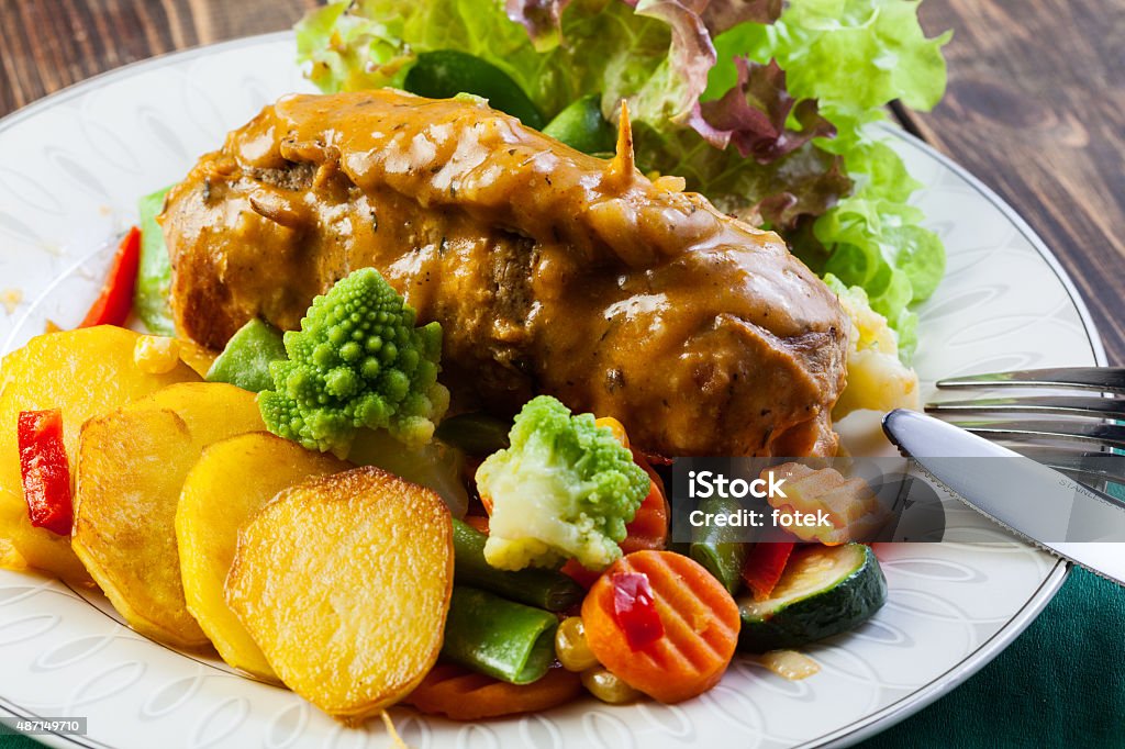 Pork rolls with prepared potatoes and vegetables Pork rolls with prepared potatoes and vegetables on plate 2015 Stock Photo