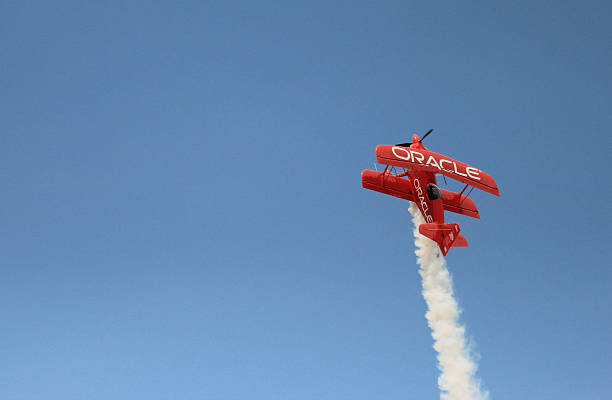 Oracle biplane in Dayton Airshow Dayton, OH, USA - June 21 2015: Team Oracle pilot Sean D. Tucker demonstrates aerobatic skills in his Oracle Challenger III biplane during the Dayton International Airshow 2015 stunt airplane airshow air vehicle stock pictures, royalty-free photos & images