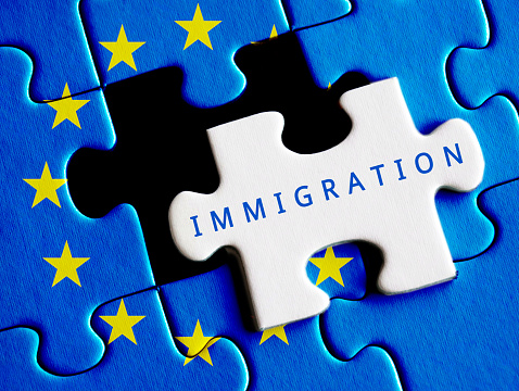 European Union crisis. Immigration text on missing puzzle.