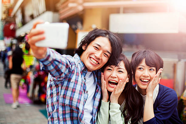 istock Group of young japanese people making selfie, Tokyo, 487152604
