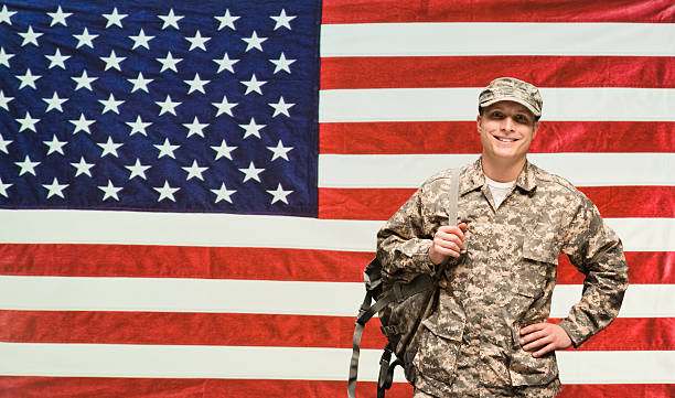 istock Smiling solider in front of American flag 487152760