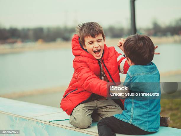 Two Brothers Playing Outdoors Stock Photo - Download Image Now - 2015, 6-7 Years, Boys