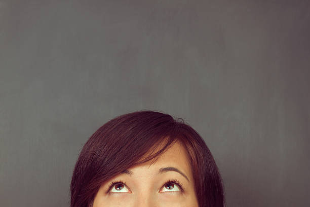 istock Woman looks up, copyspace 487152977