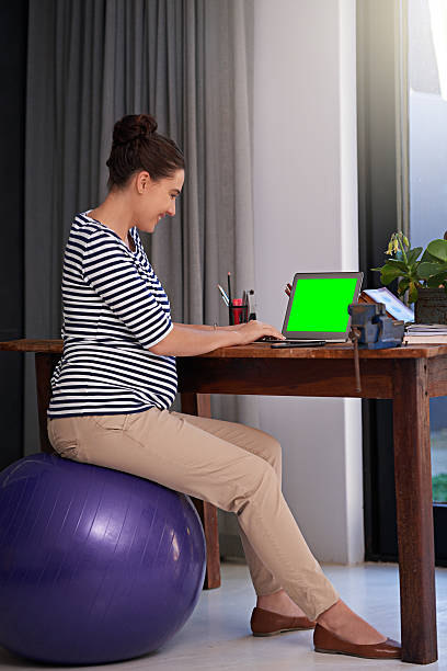istock Finishing up some work before she goes on maternity leave 487154086