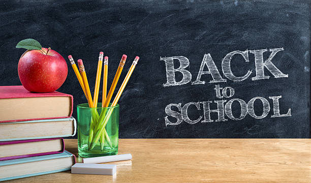 обратно в школу, написанные в панели blackboard with book - back to school blackboard education apple стоковые фото и изображения