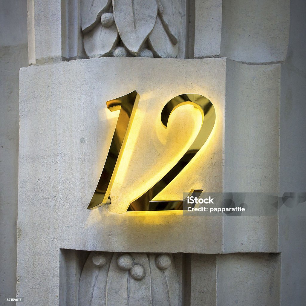 Number 12 Golden house number twelve with backlight Back Lit Stock Photo