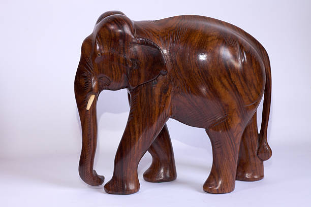 Colorful handmade and hand painted wooden elephant souvenir on white background.