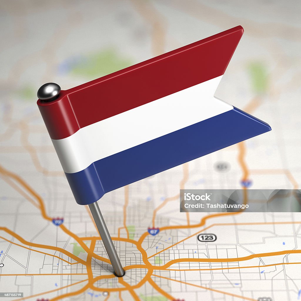 Netherlands Small Flag on a Map Background. Small Flag of Netherlands Sticked in the Map Background with Selective Focus. Amsterdam Stock Photo