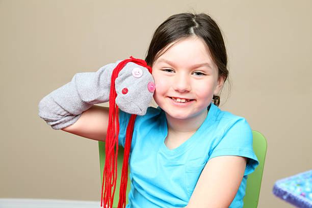 istock Smiling child showing off homemade sock puppet 487156941