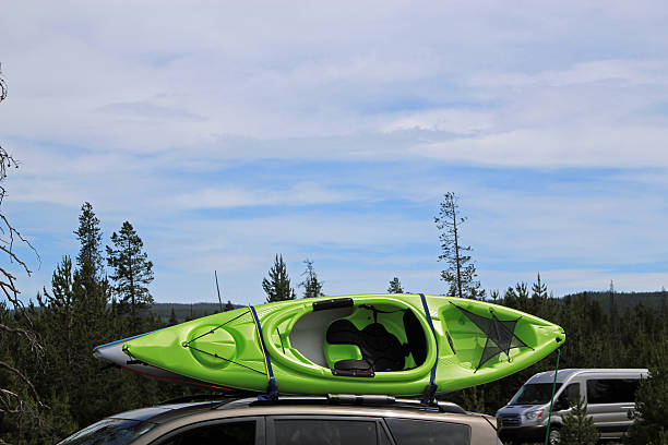 istock Colored canoe on top of a car 487157392