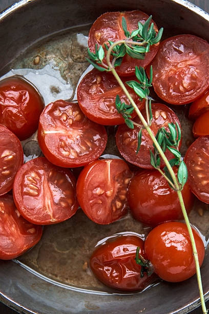 istock Fried and fresh cherry tomatoes on frying pan 487158277