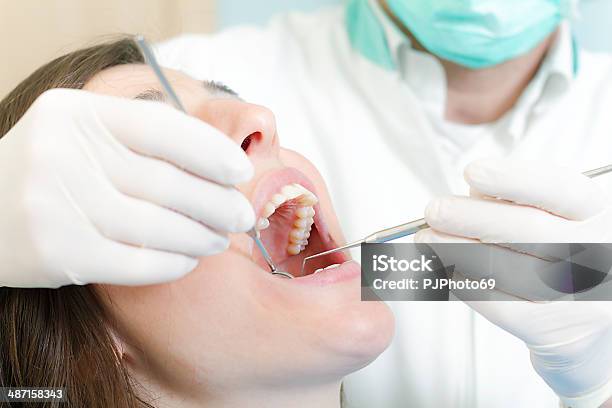 Dentist At Work With Dental Tools Stock Photo - Download Image Now - 20-24 Years, 40-44 Years, Adult