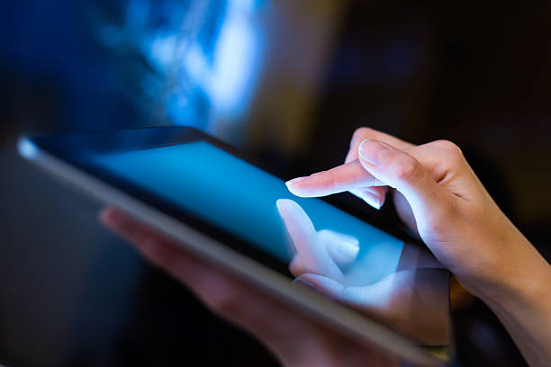 Woman holding digital tablet, closeup
