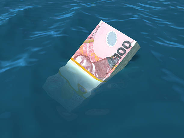 istock Money sinking in water 487159213