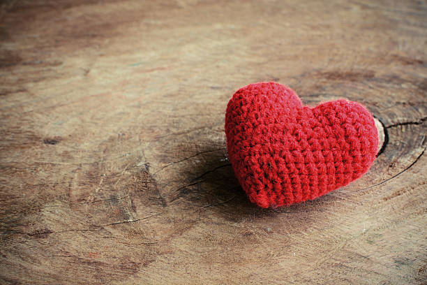istock Red heart shape on old wooden background 487162596