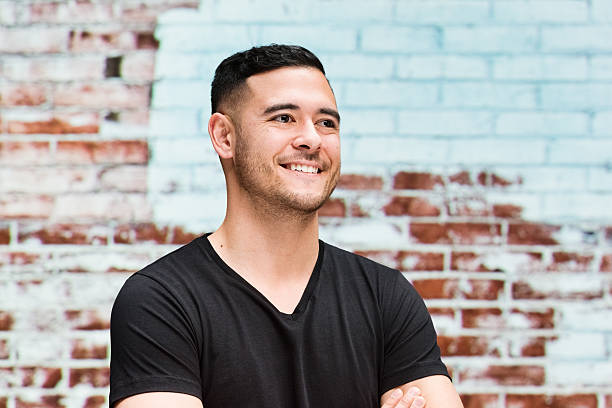 istock Smiling man in front of brick wall 487163160